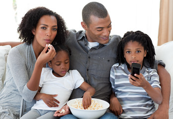 Afro-American family watching a film at home