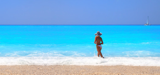 Fototapeta na wymiar tanned woman in bikini in the sea