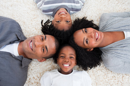 Afro-American family on floor with heads together