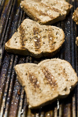 slices of bread on grill with selective focus on middle one