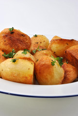 organic parsley roasties in a white bowl