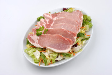some raw organic pork chop and parsley