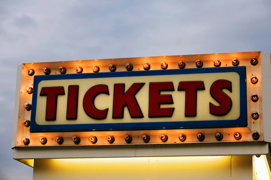 Ticket Booth Sign Illuminated At Twilight