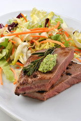 grilled rump steak with organic rosemary on a plate