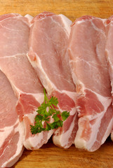 some raw organic pork chop and parsley