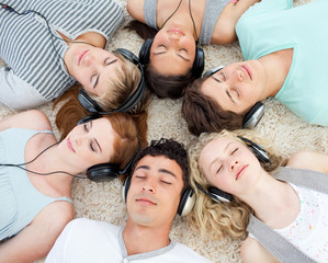 Group of friends listening to music on the floor