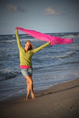 Girl waving on a beach