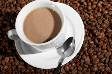 Cup with coffee, costing on coffee grain