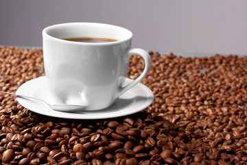 Cup with coffee, costing on coffee grain