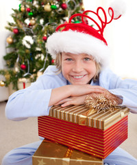 Obraz na płótnie Canvas Happy little boy with Christmas presents