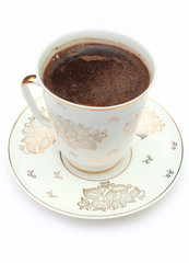 coffee cup in over plate isolated on white background