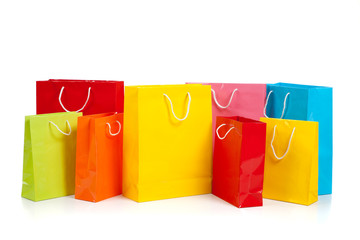 Assorted colored shopping bags on white