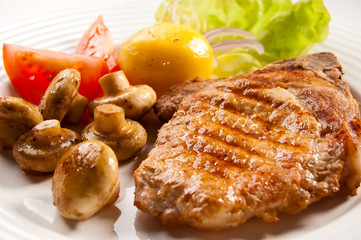 Grilled meat with boiled potatoes and vegetable salad
