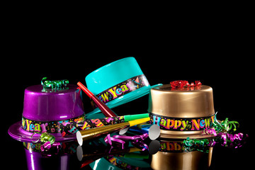 New years eve hat and noisemakers on black