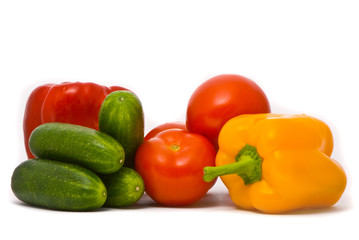 Fresh tomatoes, cucumbers and pepper on a studio white backgroun