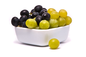 Green and blue grapes on a studio white background