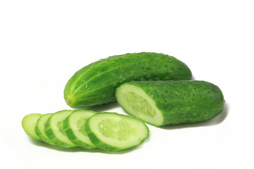 green cucumber chopped circles lying on a white plate