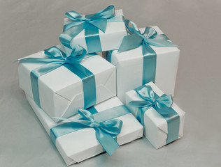 Cute white gift boxes with blue ribbon