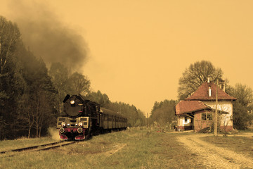 Fototapeta na wymiar Steam passenger train starting from the small station