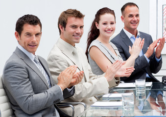 Business team applauding in a meeting