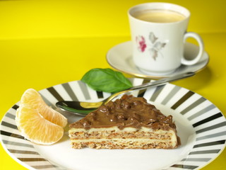 Nuts cake dessert with coffee and tangerines.