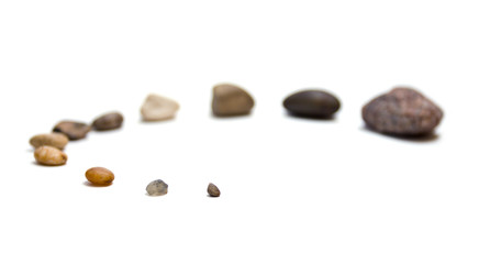 Stones scattering isolated .on white, soft focus, close-up shot