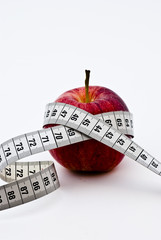 Red apple with measuring tape