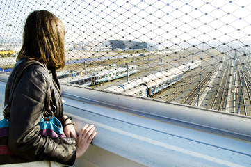 Girl watching the trains passing by