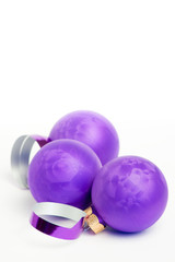 Purple christmas baubles on white background