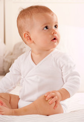 Sitting baby in a bodysuit