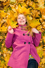 young smiling woman on the leaves