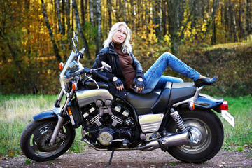 Plakat The girl the blonde on a stylish motorcycle