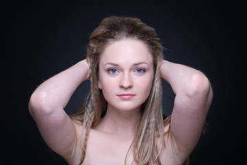 Close up portrait of beautiful blond girl on black