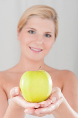 Young healthy woman with green apple