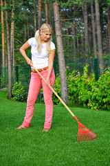 Young woman gardening with rakes