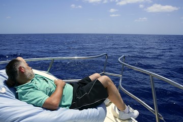 Sailor senior man having a rest on summer boat