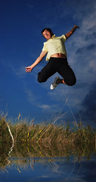 Young active man jumping, darkness
