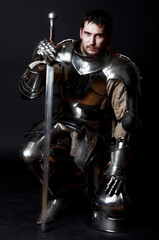 Fototapeta na wymiar Great knight holding his sword and helmet