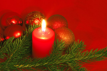 christmas still life with red candles and bolls
