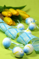 Blue Easter eggs and yellow tulips