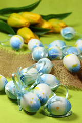 Blue Easter eggs and yellow tulips