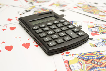 One isolated calculator in top of a set of cards