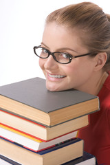 Caucasian student in eye glasses on pile of book