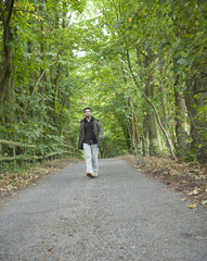 Fototapeta premium Man walking along a country lane