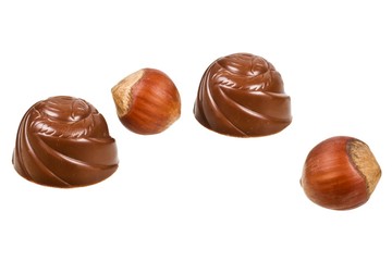 Chocolates and hazelnuts isolated on a white background