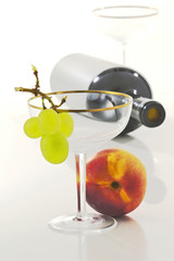 still life with peach, grape and glasses