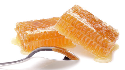 honeycomb with spoon on white