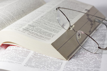 closeup of opened books with glasses