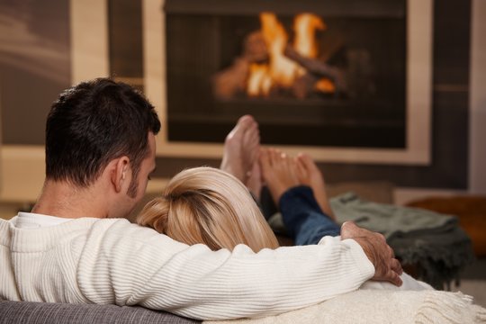 Couple sitting at fireplace