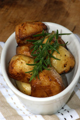 organic rosemary roasties in a white bowl